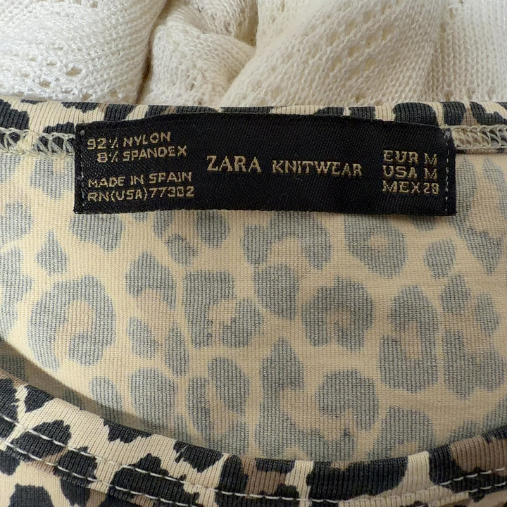 Beige leopard print short-sleeve fitted top by Zara Knit, back view on model