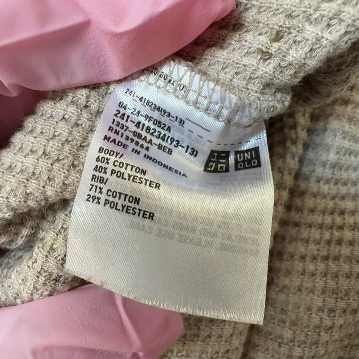 Beige ribbed cotton knit sweater back view showing relaxed fit and curved hem