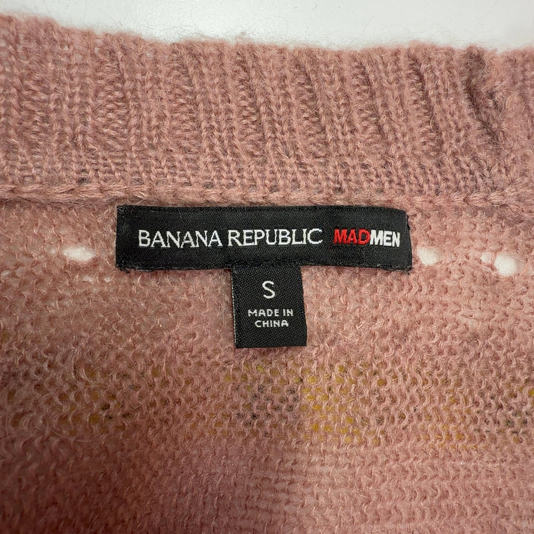 Tag view of beige cropped cardigan sweater showing textured knit pattern and three-quarter sleeves
