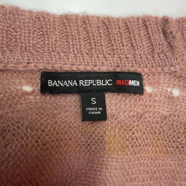 Tag view of beige cropped cardigan sweater showing textured knit pattern and three-quarter sleeves