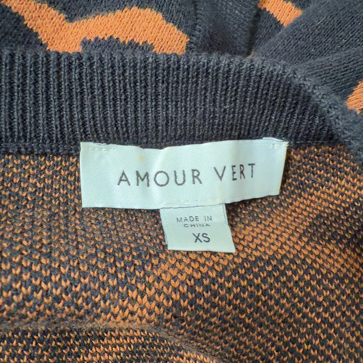 Black and orange tiger stripe cardigan by Amour Vert, back view showing full length and pattern