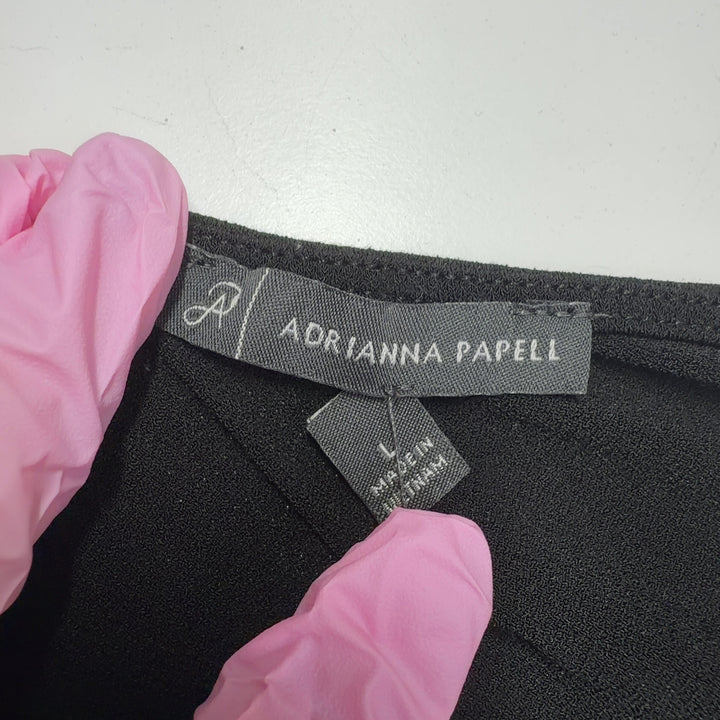 Black V-neck puff sleeve top with dotted mesh details by Adrianna Papell, back view