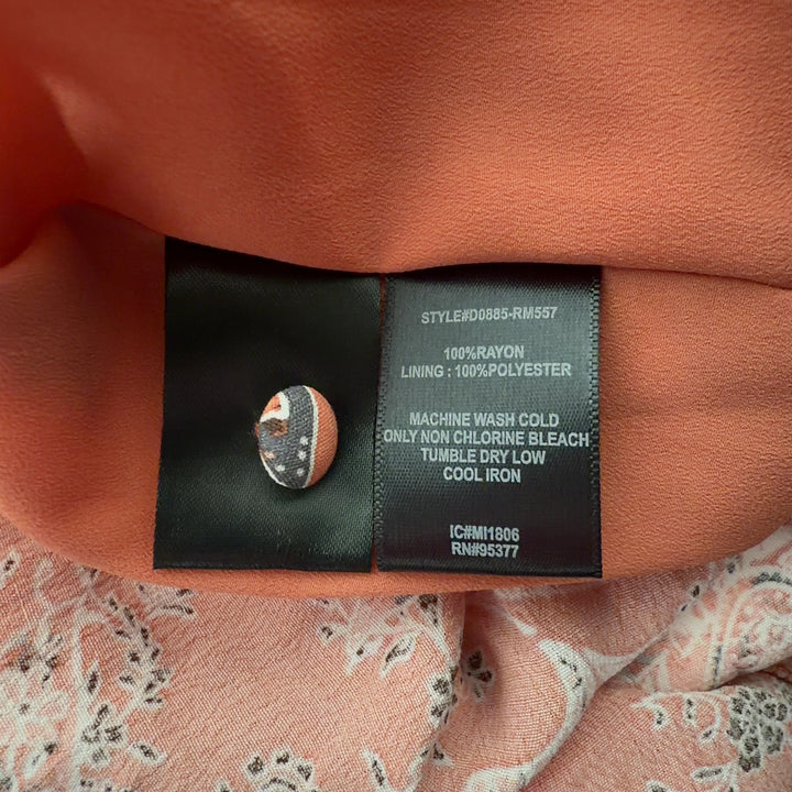 Tag view of coral floral maxi dress showing ruffled cold-shoulder detail and button-front design