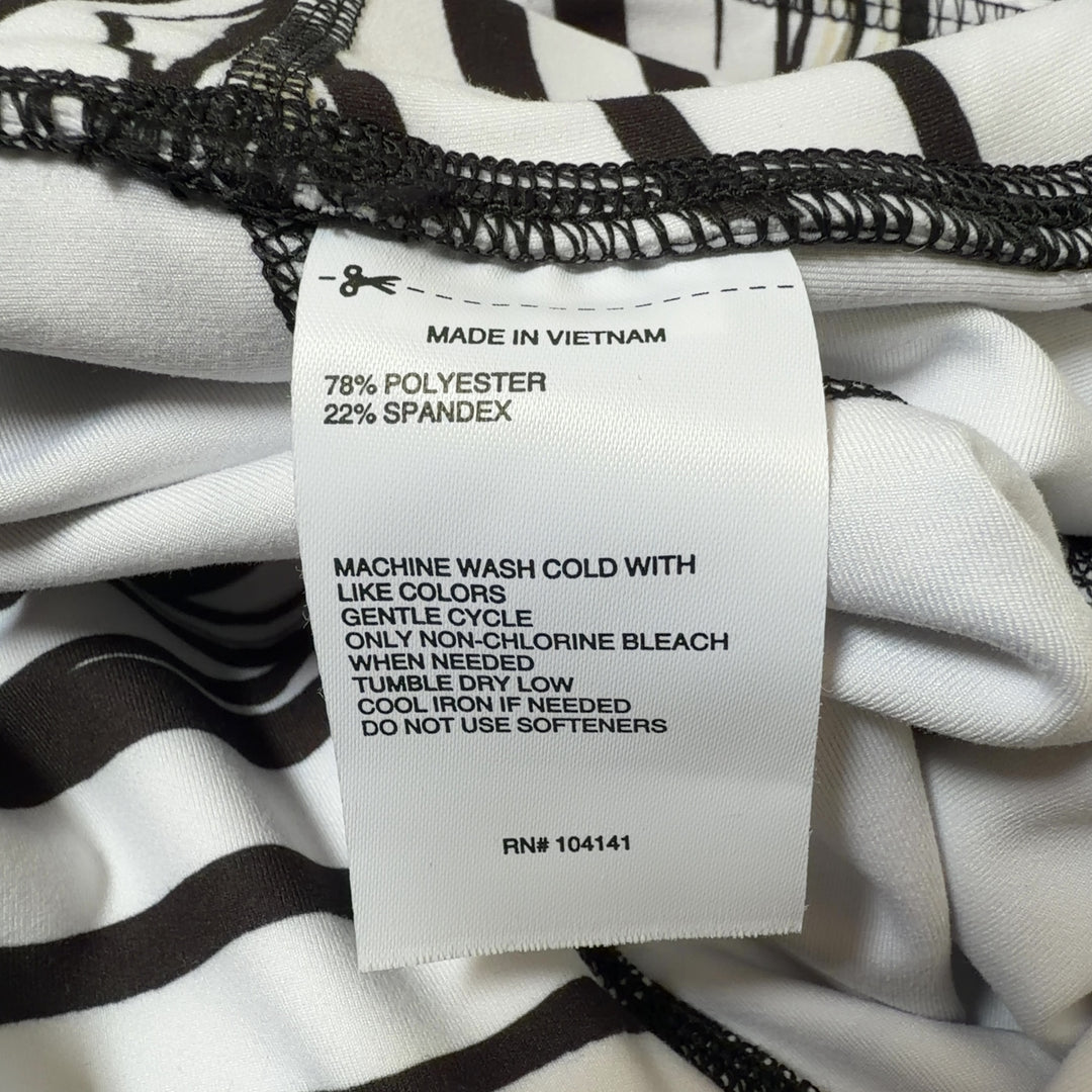 White and black striped DSG capri leggings with high-waisted design, side view