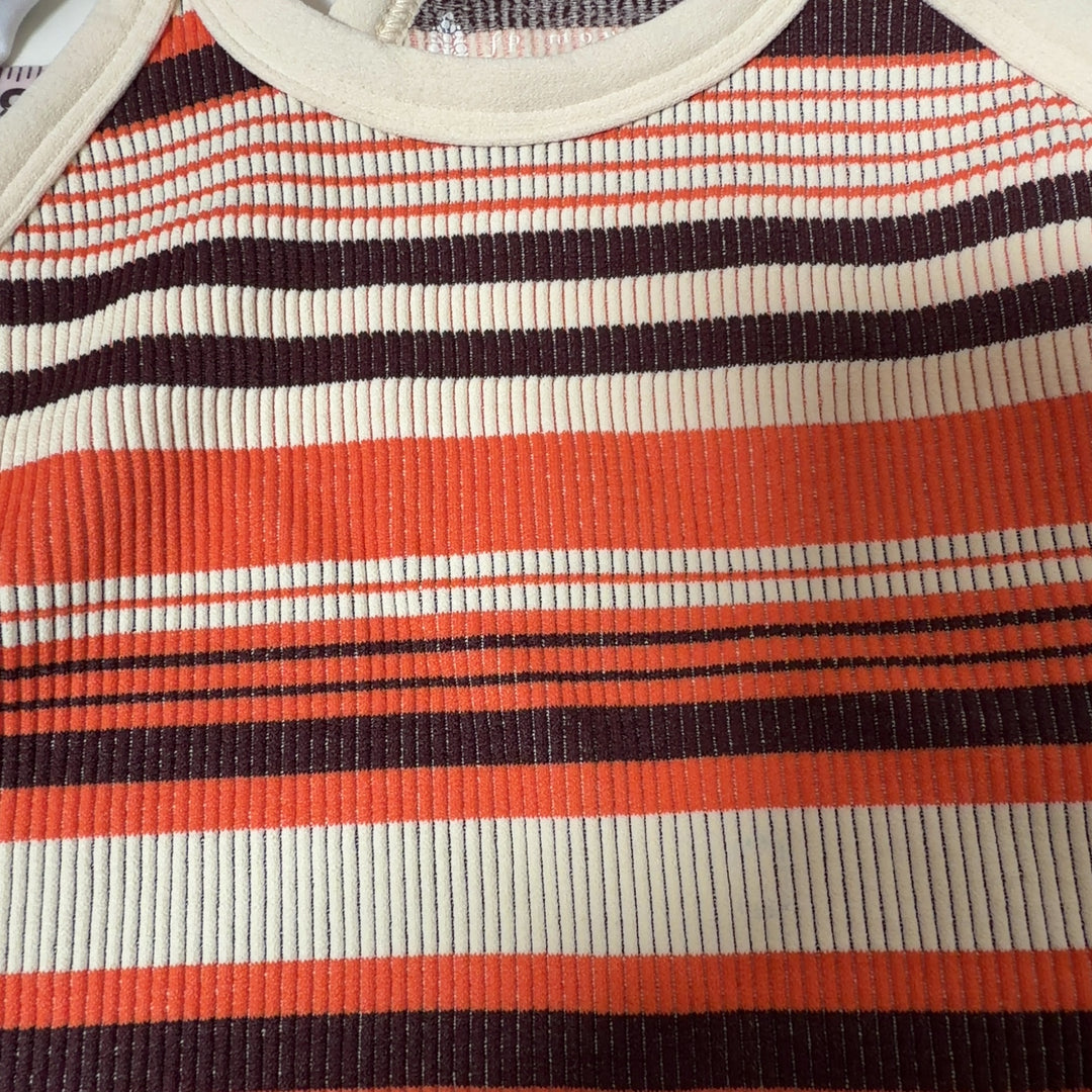Tag view of orange striped athletic crop top sports bra showing supportive design and fit