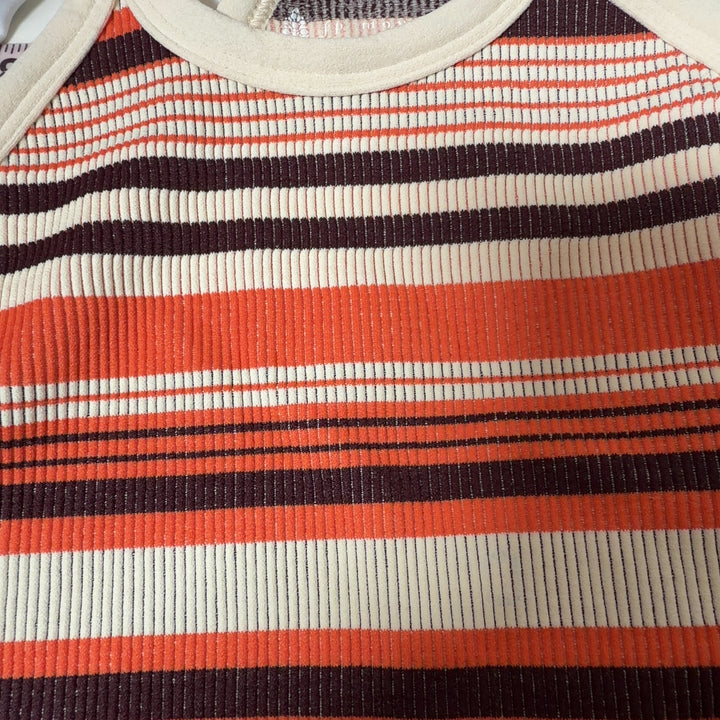 Tag view of orange striped athletic crop top sports bra showing supportive design and fit