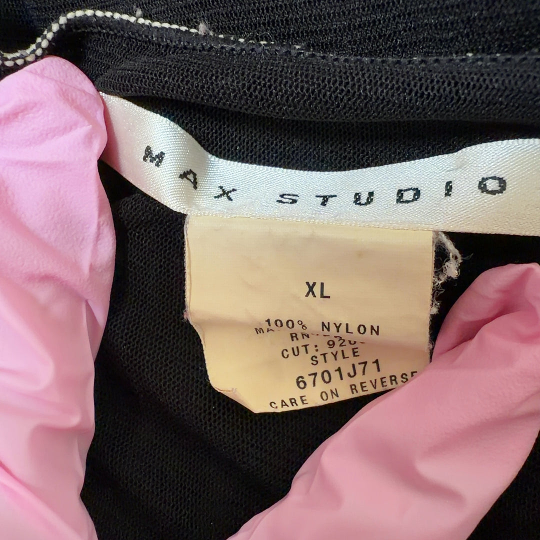 Tag view of black flutter sleeve v-neck top showing relaxed fit and contrast stitching