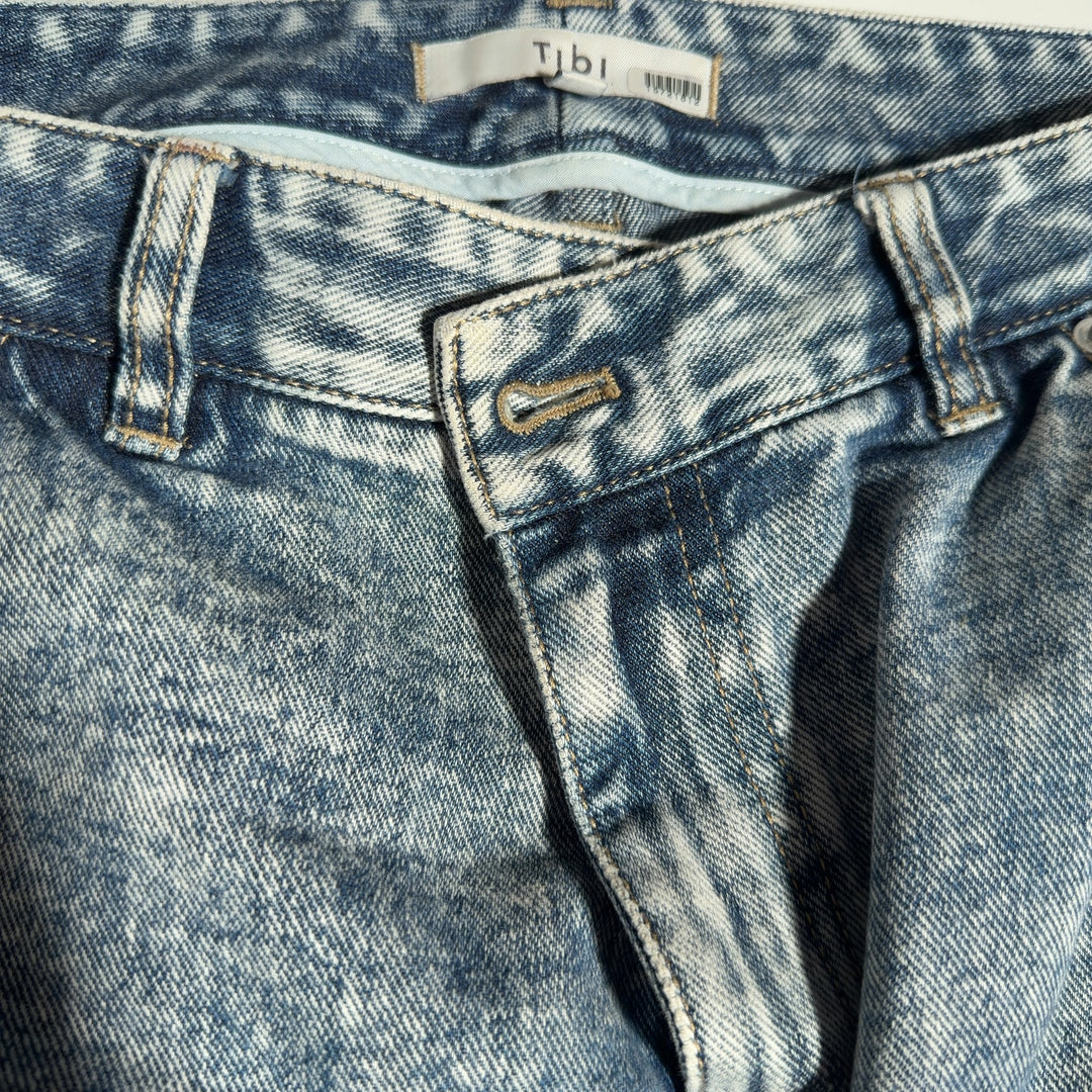 Side view of Tibi acid wash cropped jeans showing the relaxed fit and ankle-length cropped hem