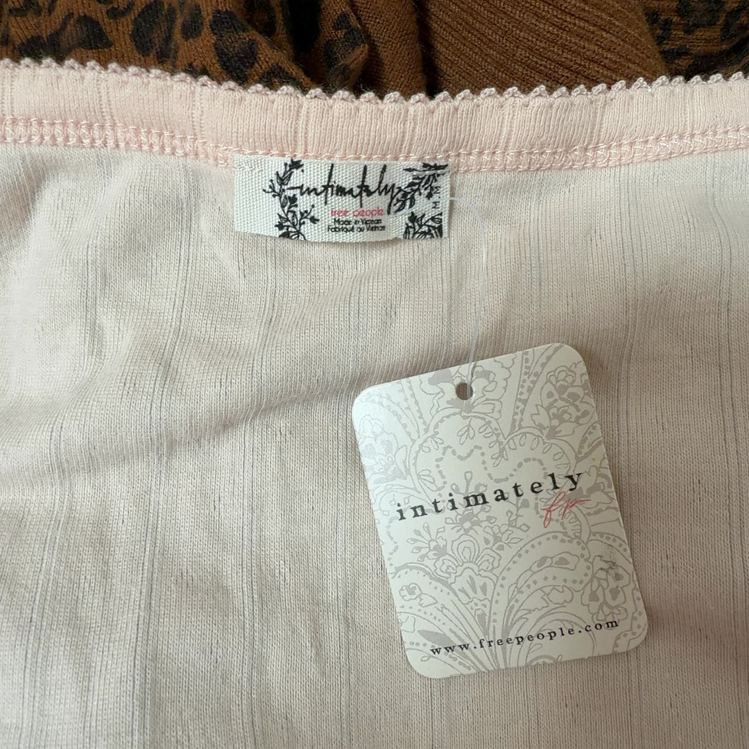 Cream ribbed crop top back view showing cropped silhouette and short sleeves