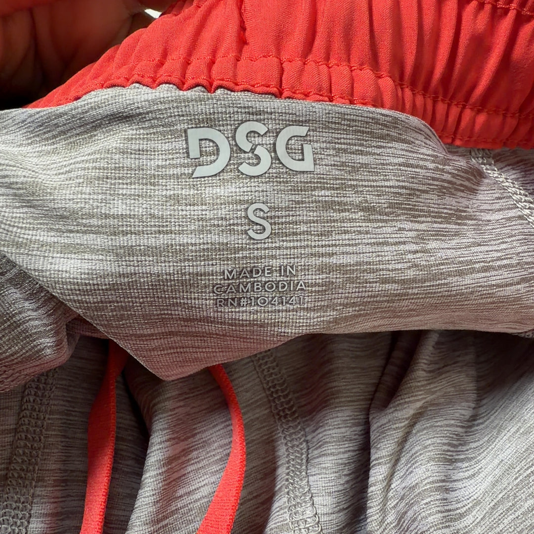 Red athletic shorts with gray compression liners, back view displaying relaxed fit and mid-thigh length
