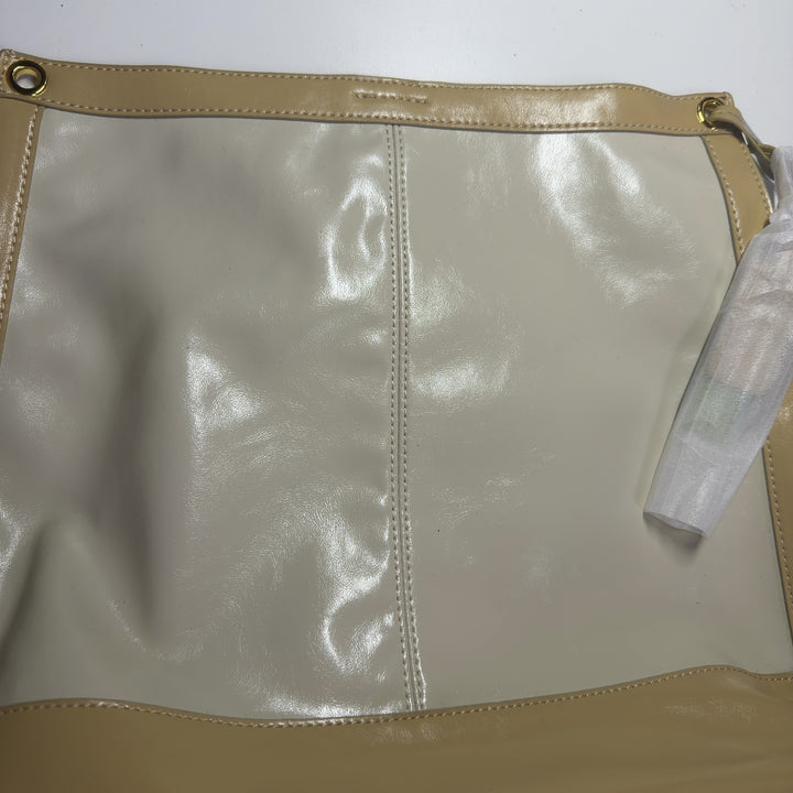 Tag view of SilkRoll gold leather crossbody bag worn as shoulder bag, displaying two-tone leather construction and polished hardware