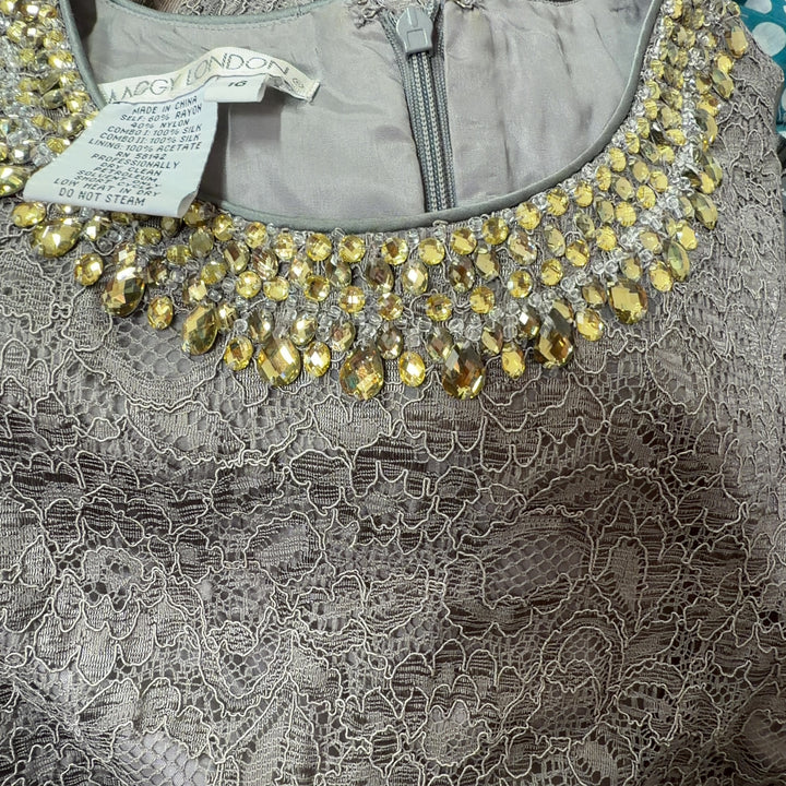 Tag view of gray lace cocktail dress showing sleeveless silhouette and textured lace pattern