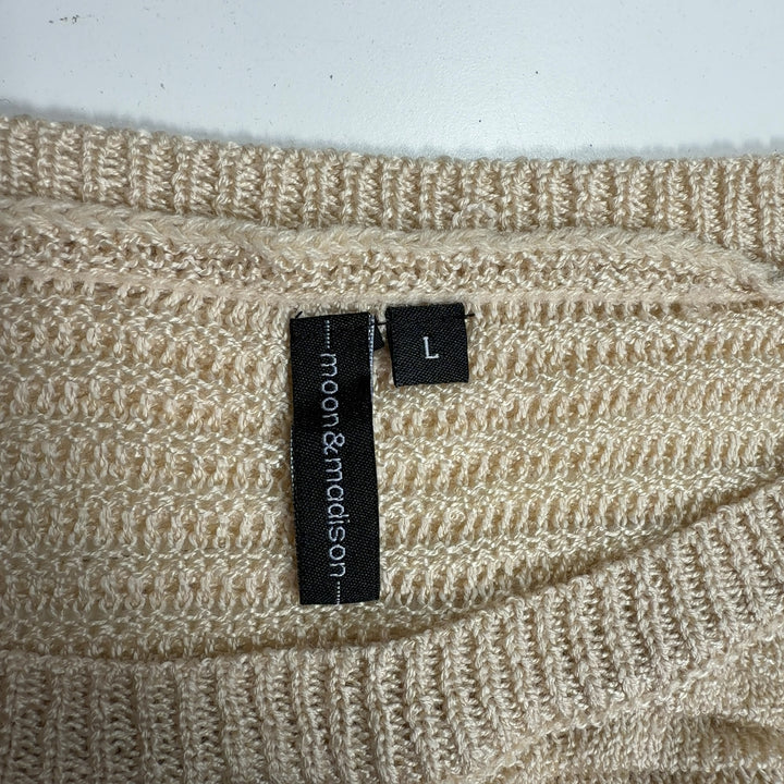 Cream ribbed knit sweater with balloon sleeves, back view showing relaxed silhouette