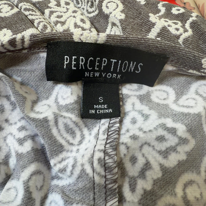Tag view of taupe geometric print A-line dress showing full ornamental pattern and relaxed A-line silhouette