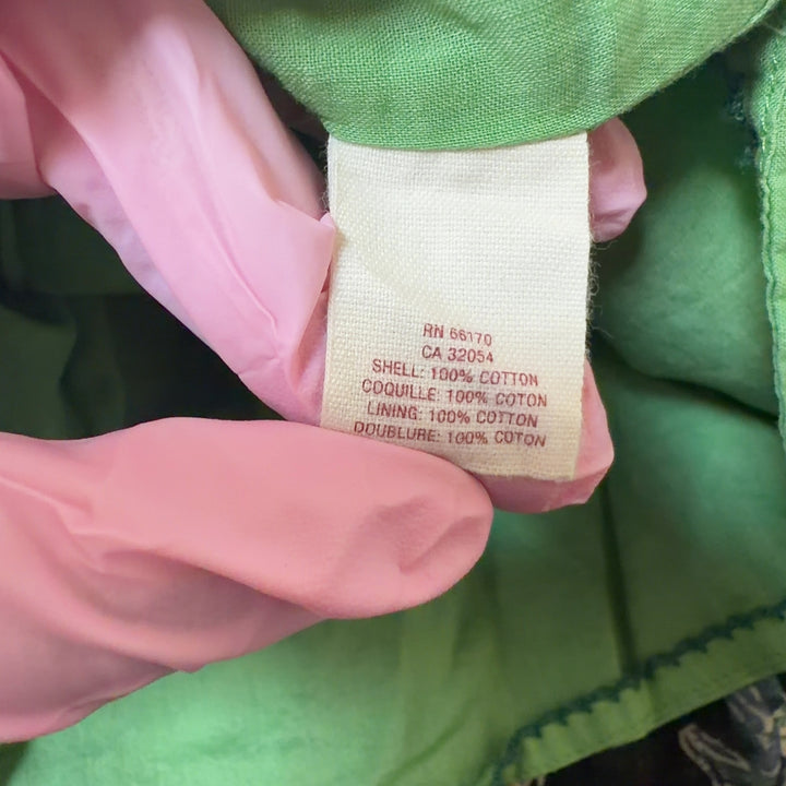 Tag view of black floral wrap midi dress showing A-line silhouette and full skirt with botanical print