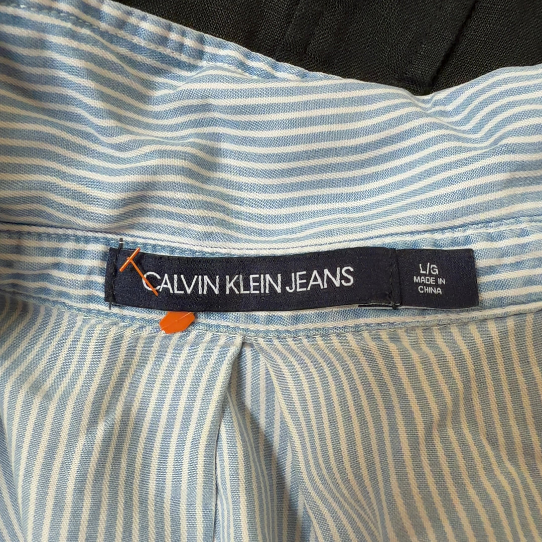Light blue and white striped Calvin Klein Jeans button-up shirt, back view showing relaxed fit