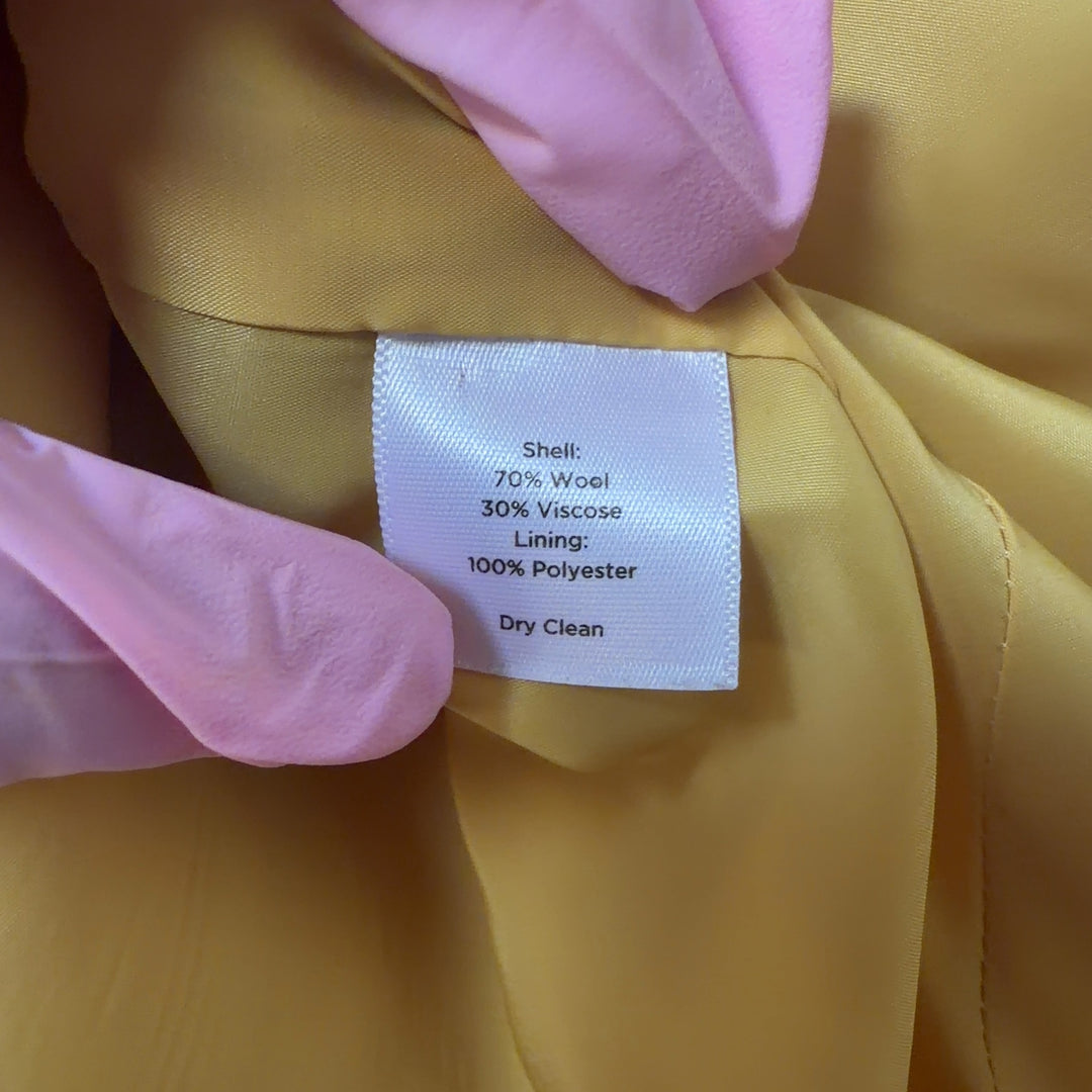 Tag view of yellow tailored blazer showing cropped length and structured silhouette