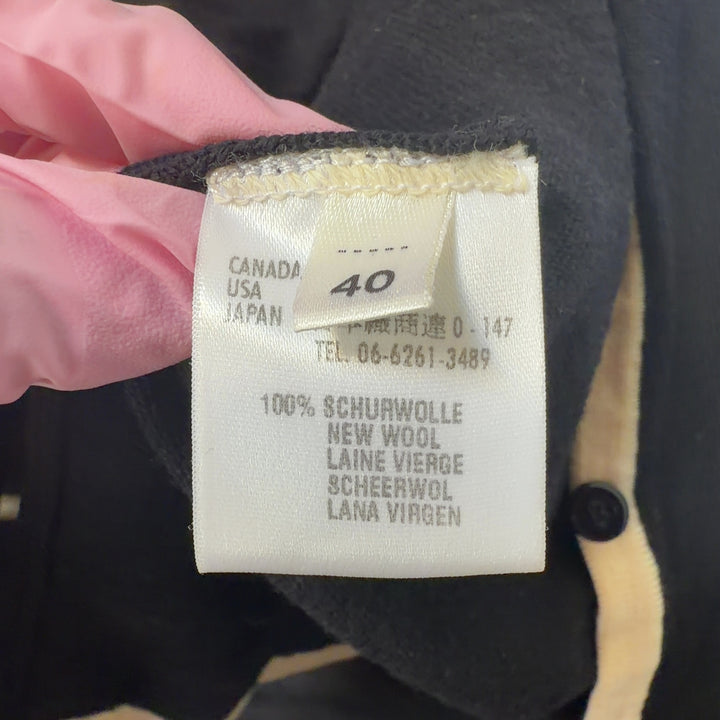 Tag view of black ESCADA wool cardigan with cream trim detailing and three-quarter length sleeves