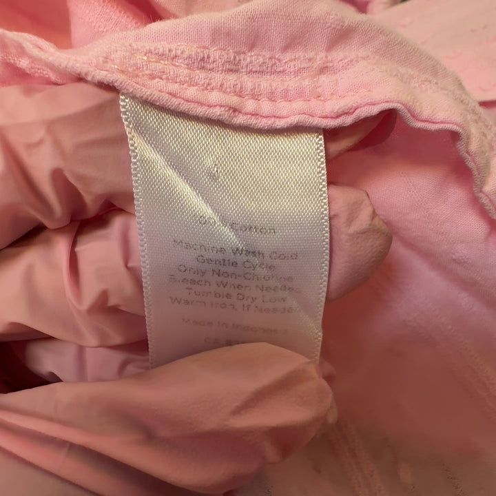 Tag view of pink cotton button-down shirt showing relaxed fit and full-length sleeves