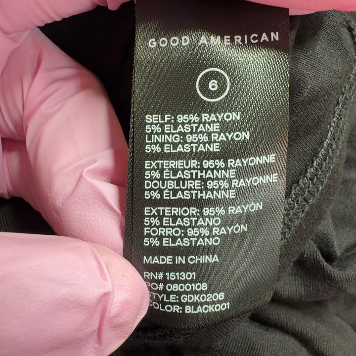 Black strapless ruched maxi dress by Good American, back view displaying the sophisticated ruched design and maxi length