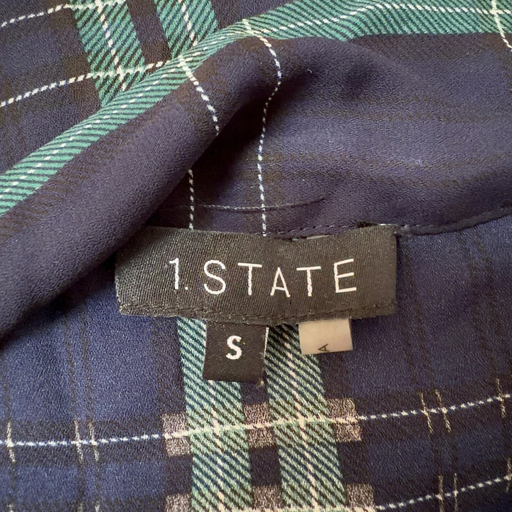 Navy and green plaid tie-neck blouse with long sleeves, back view