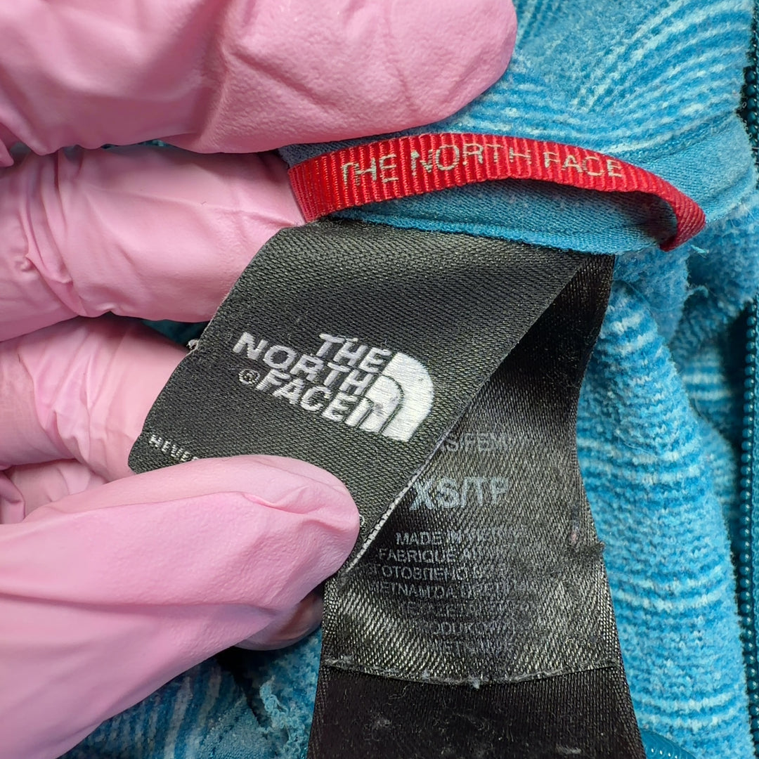 The North Face blue heathered striped hooded zip-up jacket back view on model
