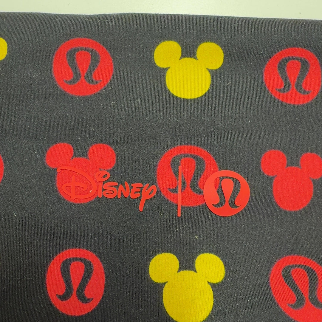 Tag view of multicolor Mickey Mouse print Lululemon leggings showing full-length cropped fit and pattern coverage