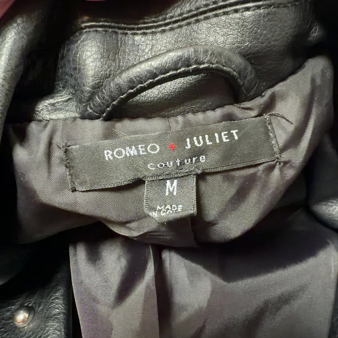 Black studded biker jacket with floral embroidery on sleeves, back view
