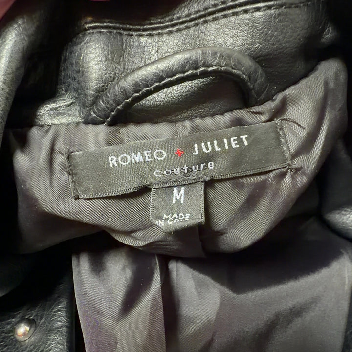 Black studded biker jacket with floral embroidery on sleeves, back view