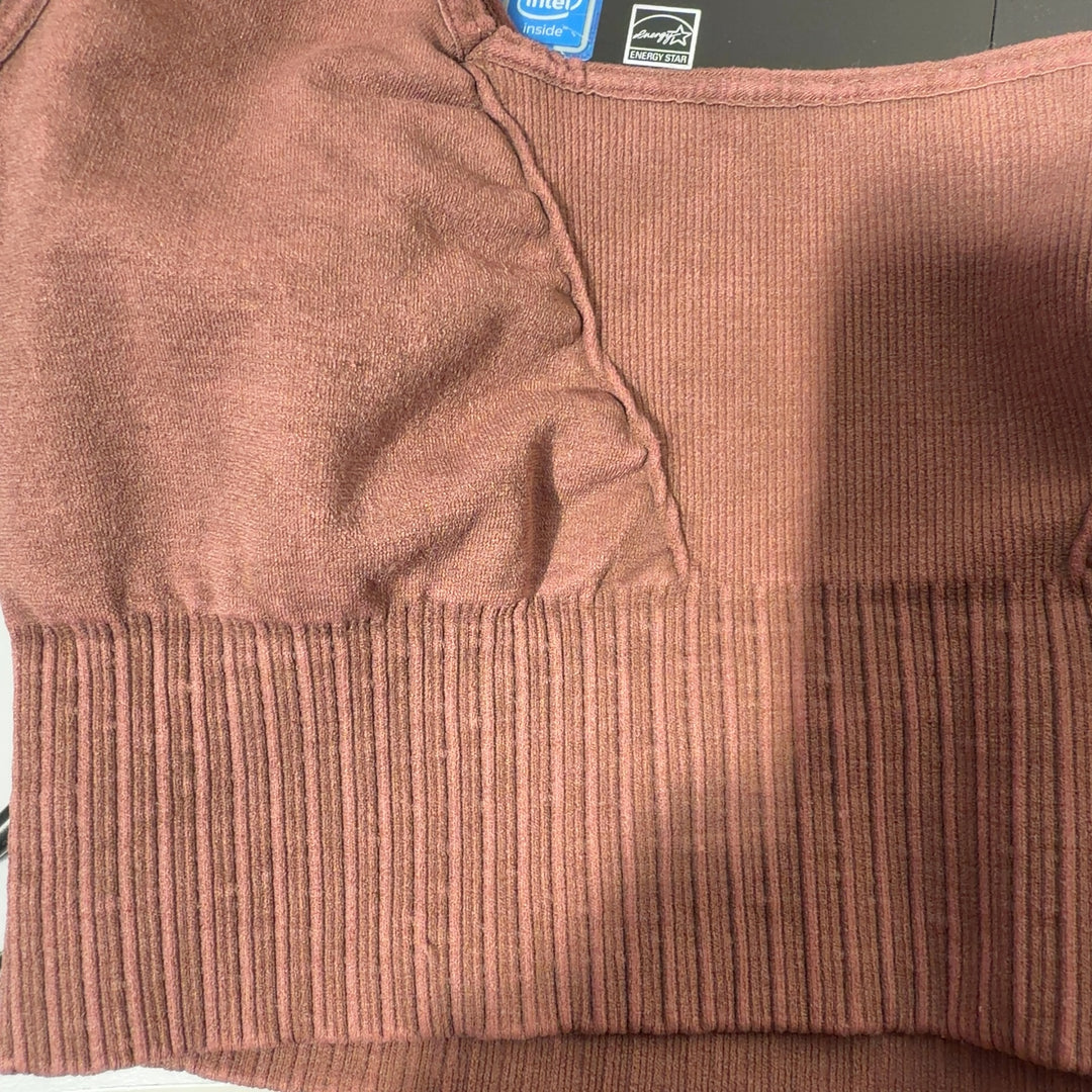 Burgundy ribbed sports bra with square neckline and black leggings, back view