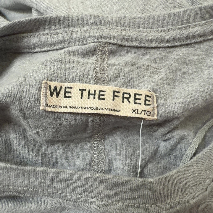 Gray organic cotton short sleeve tee by WE THE FREE, back view on model wearing black leggings