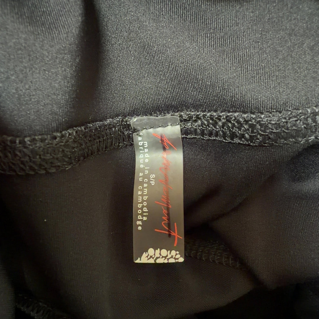 Black activewear shorts with white trim, high-waisted design, back and side view on model