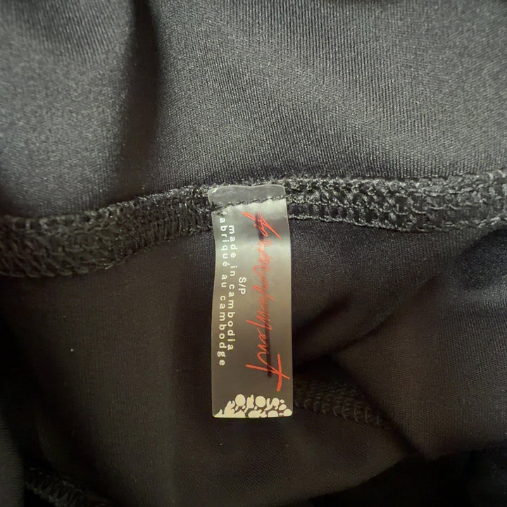Black activewear shorts with white trim, high-waisted design, back and side view on model