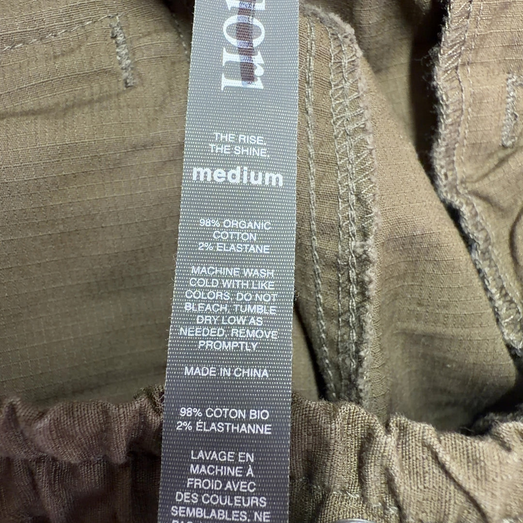 Tag view of brown cargo pants showing relaxed fit and rolled cuff detail