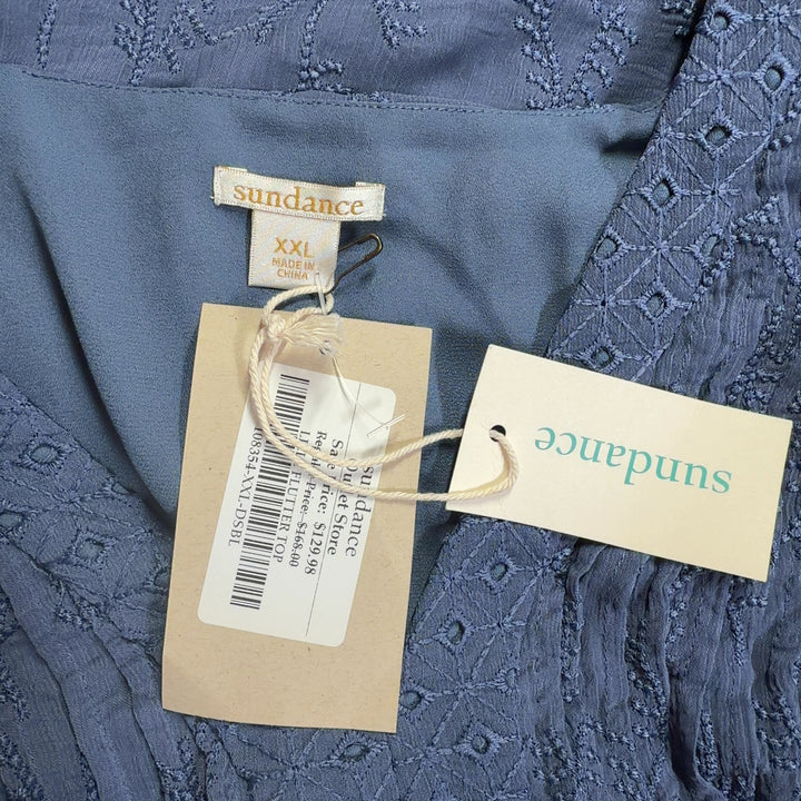 Blue pleated top with ruffled lace short sleeves, back view