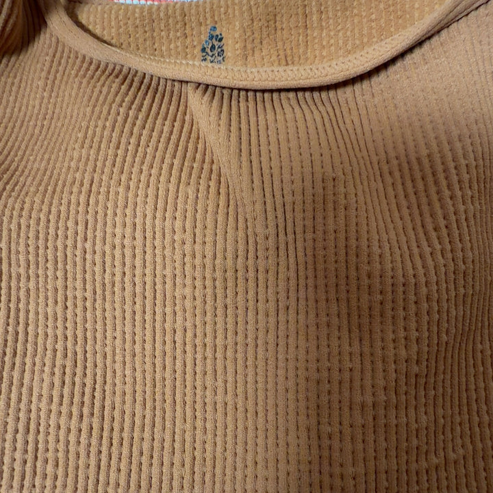 Orange ribbed crop tank top back view, showing fitted crop length design