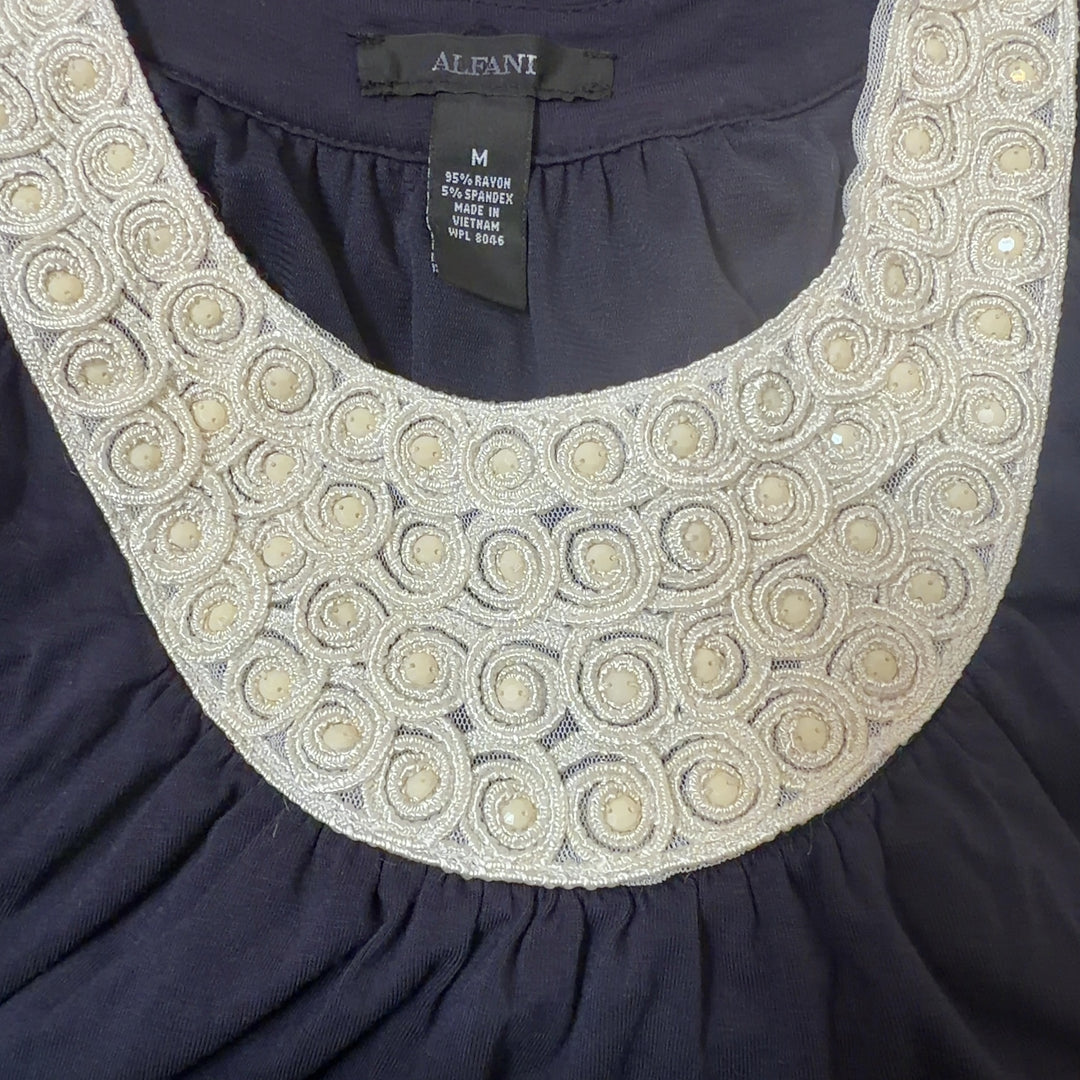 Tag view of navy Alfani tank top showing cream beaded neckline detail and relaxed fit silhouette
