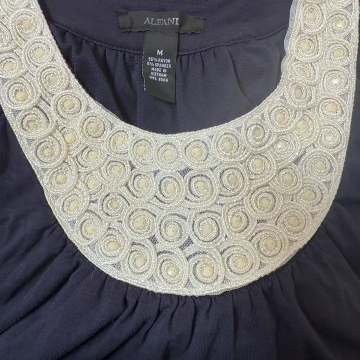 Tag view of navy Alfani tank top showing cream beaded neckline detail and relaxed fit silhouette