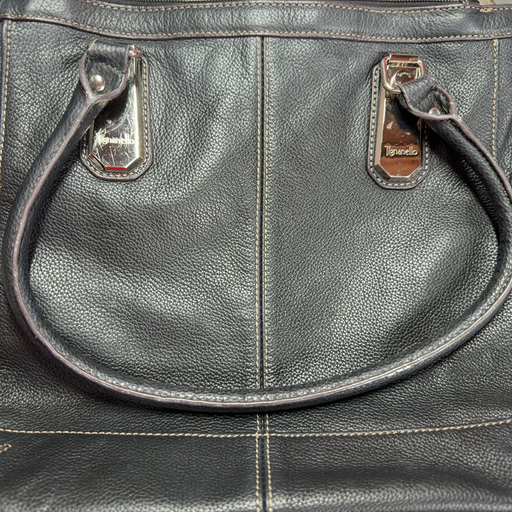 Black leather and canvas Tignanello shoulder tote bag worn on shoulder, side view