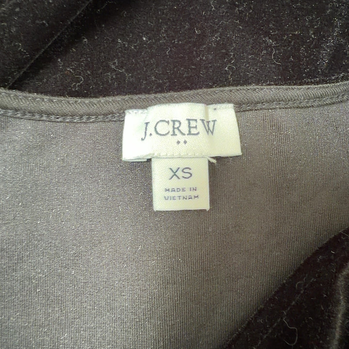 Black velvet sleeveless V-neck top by J.Crew, back view on model