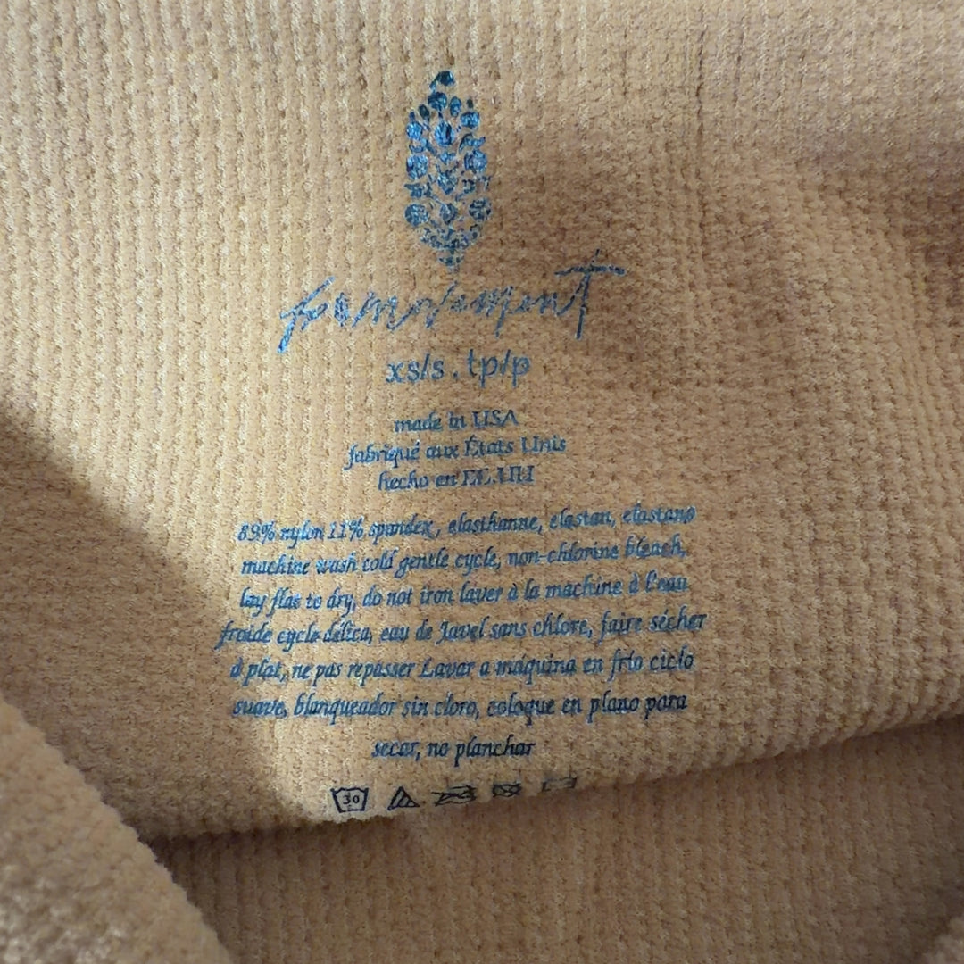 Orange ribbed crop tank top back view, showing fitted crop length design