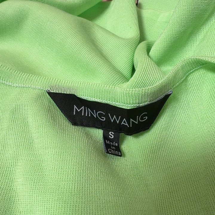 Green v-neck sleeveless knit tank top by MING WANG, back view on model
