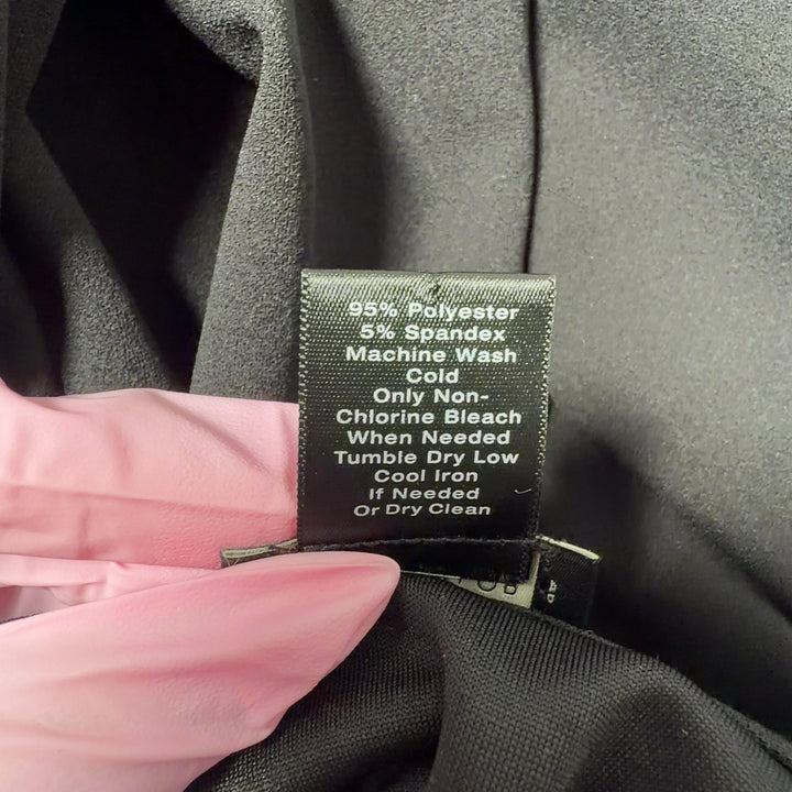 Black ruffle sleeve blouse back view, showing relaxed fit and three-quarter length sleeves