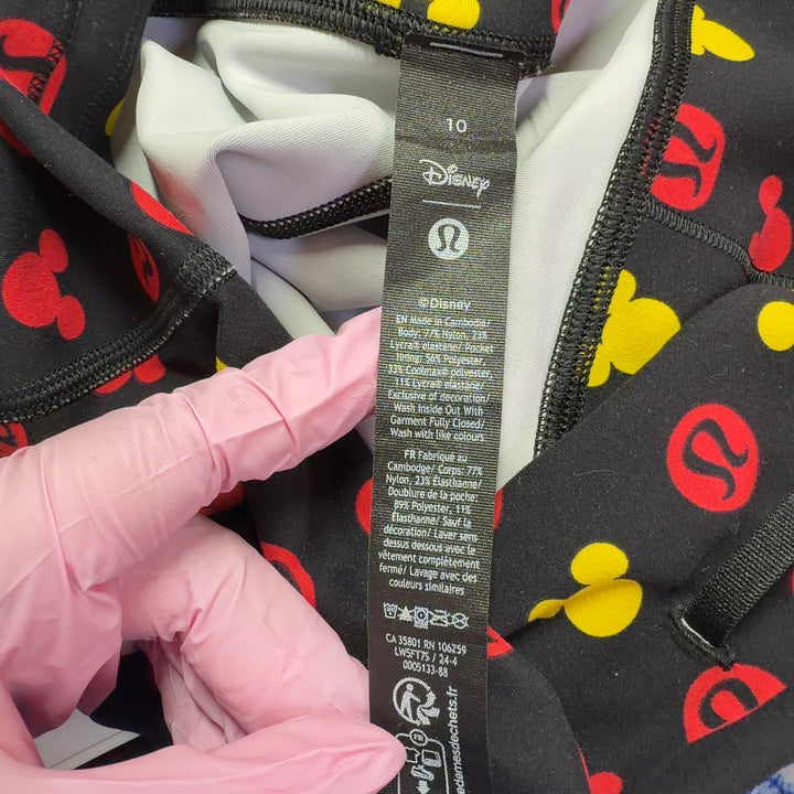 Tag view of multicolor Mickey Mouse print Lululemon leggings showing full-length cropped fit and pattern coverage