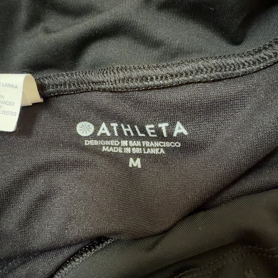 Black athletic shorts back view displaying sleek design and flattering silhouette with wraparound waistband
