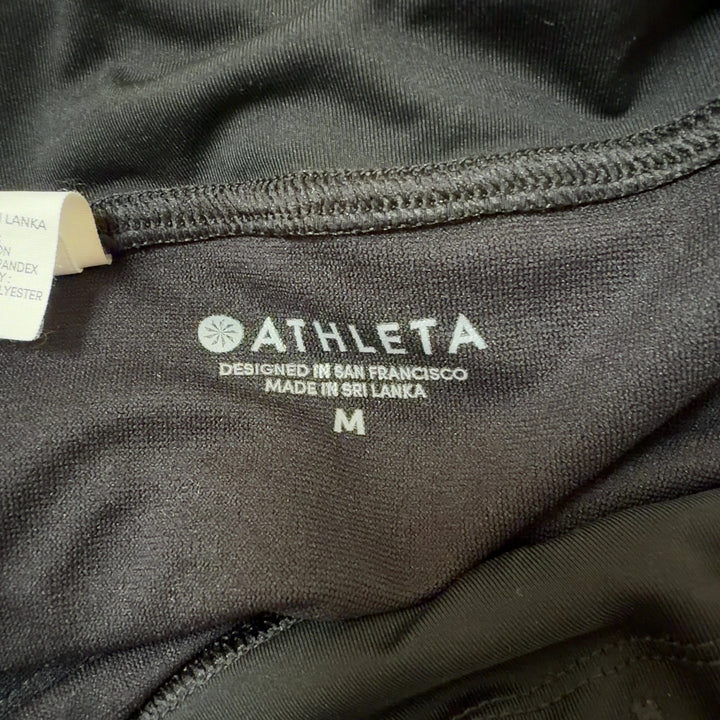 Black athletic shorts back view displaying sleek design and flattering silhouette with wraparound waistband