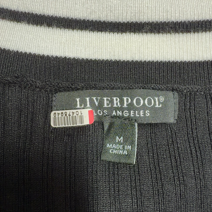 Black ribbed cardigan with white stripe trim showing back view and side profile