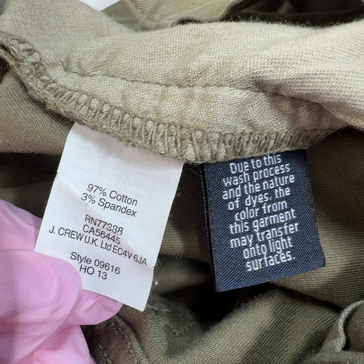 Tag view of olive green cropped cargo pants showing relaxed fit and ankle length