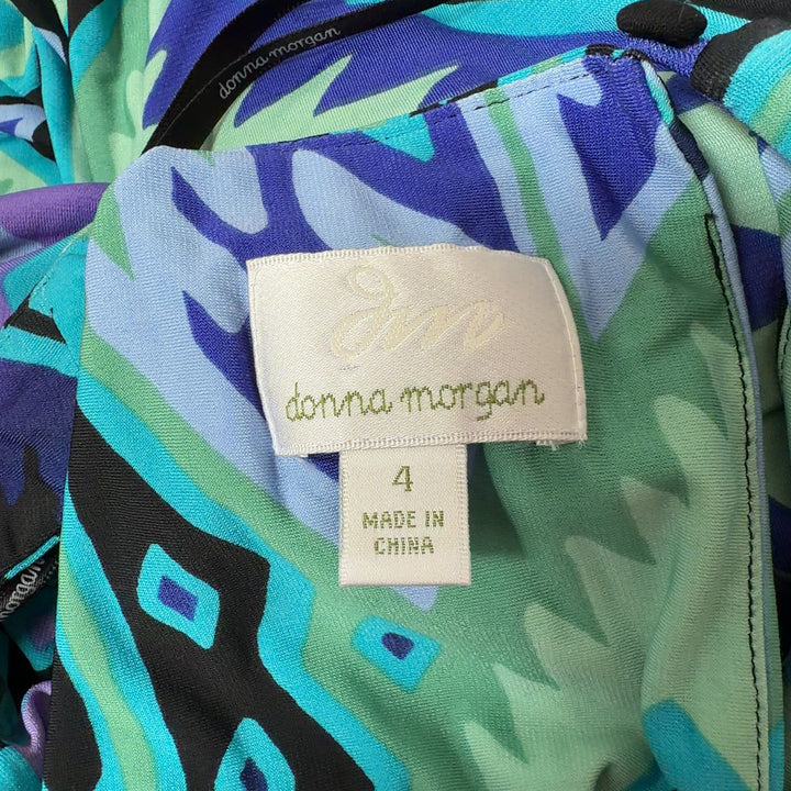 Tag view of blue geometric maxi tank dress showing flowing silhouette and continuous geometric pattern