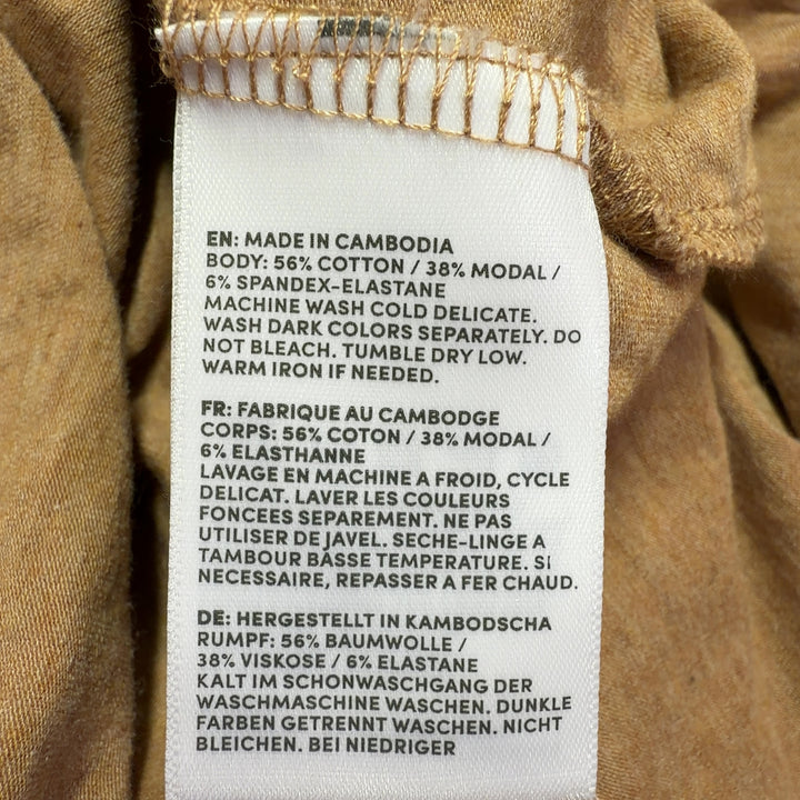 Tag view of camel turtleneck long sleeve top showing relaxed silhouette and length